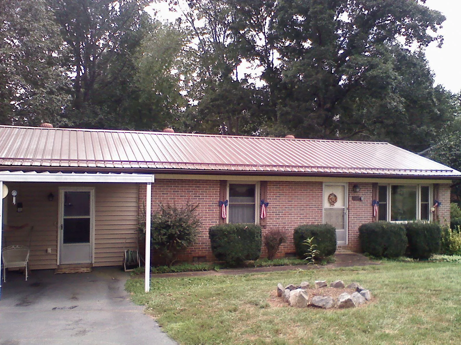 Bronze metal roof and carport on a brick ranch home in Littleton